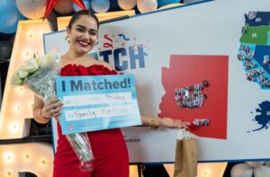 College of Medicine – Phoenix student Jovanna Figueroa poses in front of the Match Day map.UArizona Health Sciences