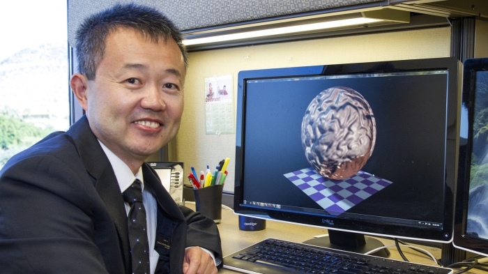 Professor Yalin Wang at work in his office. The researcher in the School of Computing and Augmented Intelligence and his team have published a series of papers in the peer-reviewed research journal JAMA Ophthalmology that outline their innovative projects. Photo by Nora Skrodenis/ASU