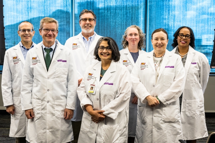 Priya Radhakrishnan (front, center), chief academic officer of HonorHealth and vice dean of clinical affairs and graduate medical education in the Shufeldt School, poses with other Shufeldt School faculty and administrators. From left: Tony Avellino, Doug Lake, Jeff Kingsbury, Heather Clark, Karen Anderson and Tanisha Price-Johnson. Photo by Charlie Leight/ASU News